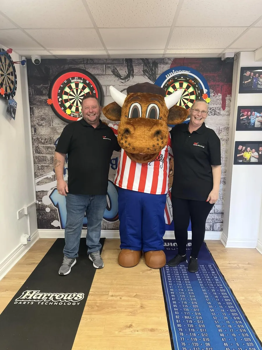 A member of the PBC team with Bully behind the counter