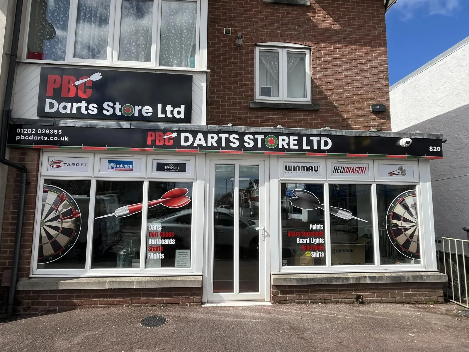 The PBC Darts Store Ltd shopfront at number 820, with Target, Unicorn, Harrows, Winmau and Red Dragon signs above the windows